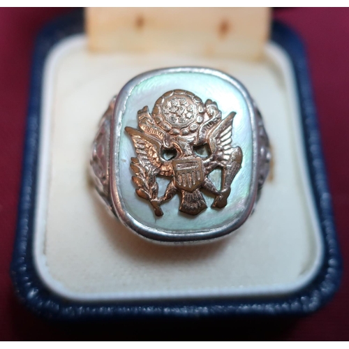 166 - An American white and yellow metal mother of pearl marine corp signet ring