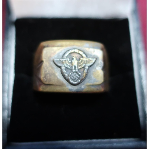 169 - A German third reich brass signet ring with inset eagle above swastika