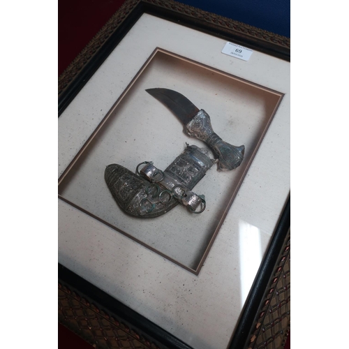 69 - Framed and mounted small jambiya dagger with white metal overlay detail in fitted display case
