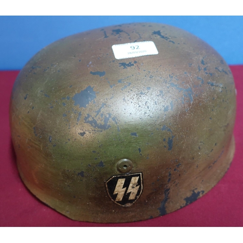92 - German steel para helmet with leather liner and painted SS decal, various stamp marks to the inside ... 