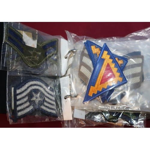 201 - Album of various assorted embroidered cloth military badges, British and American