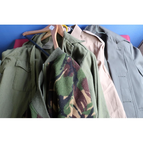 232 - Quantity of British military clothing including shirts, raincoats, woolly pully, jumpers, thermal we... 