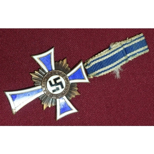 129 - German WWII Third Reich enamel Mothers Cross medal, the reverse marked 16th December 1938