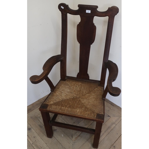 83 - 18th/19th C Oak country style broad seated armchair with drop-in rush seat, on square supports