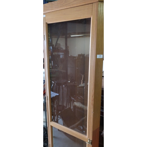 110 - Modern light oak corner fitting cabinet enclosed by single glazed door (height 195cm)