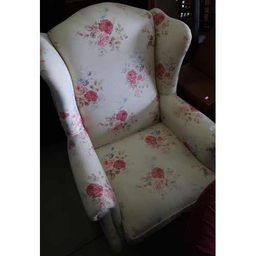 134 - Victorian style wing back upholstered armchair on tapering supports