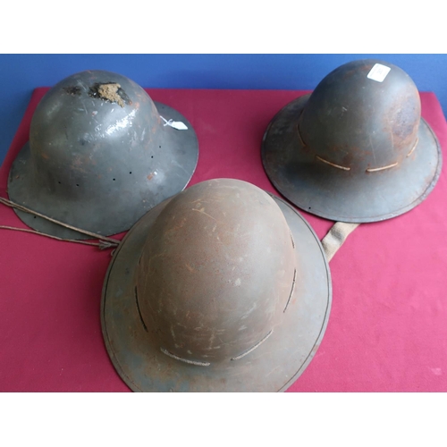 50 - Three WWII British steel helmets, two complete with liners, one marked S.M.LD 1941 (3)