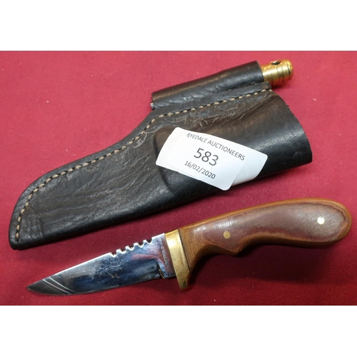 76 - Sheffield made sheath knife with 2 3/4 inch blade, brass cross piece and leather sheath, with striki... 