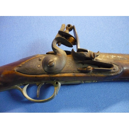 65 - Indian flintlock carbine with 30 1/2 inch barrel with brass mounts and trigger and butt guards, the ... 