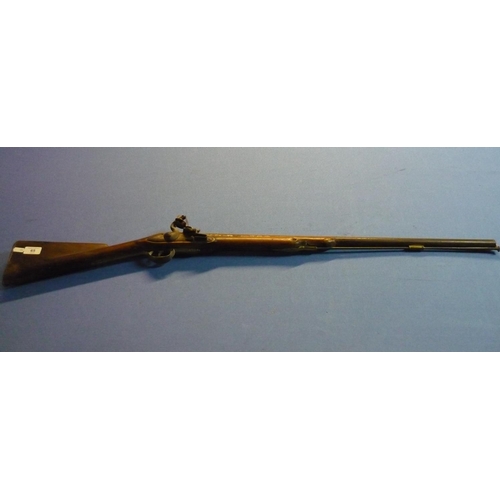 65 - Indian flintlock carbine with 30 1/2 inch barrel with brass mounts and trigger and butt guards, the ... 