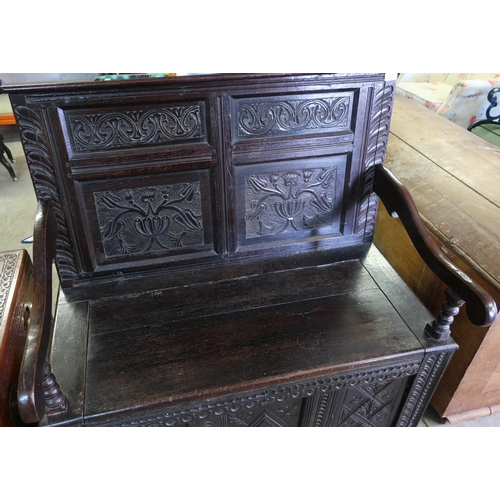 321 - Carved dark oak hall bench with four carved panels to the back, lift up box seat and three further c... 