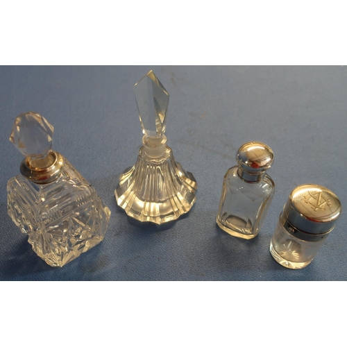 31 - Three silver hallmarked topped glass scent bottles and another glass scent bottle (4)