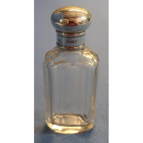 31 - Three silver hallmarked topped glass scent bottles and another glass scent bottle (4)