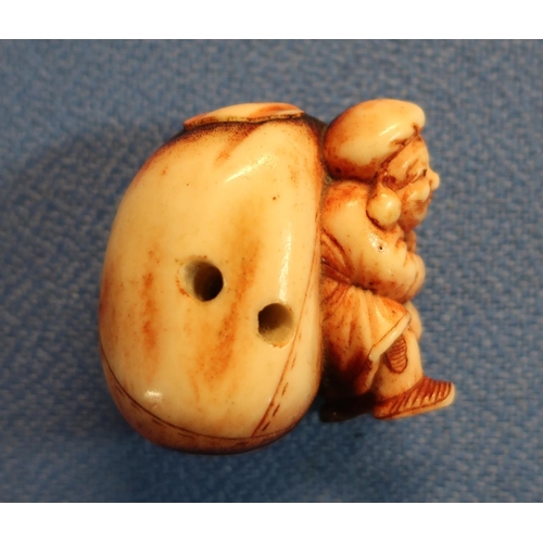 47 - 19th C carved ivory Netsuke in the form of a Dutchman  carrying a sack (height 4cm)