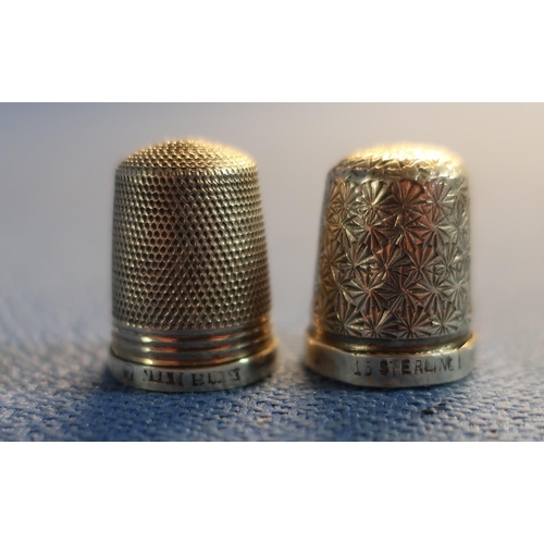 62 - Three silver hallmarked thimbles, a folding button hook and a Royal Worcester thimble (5)