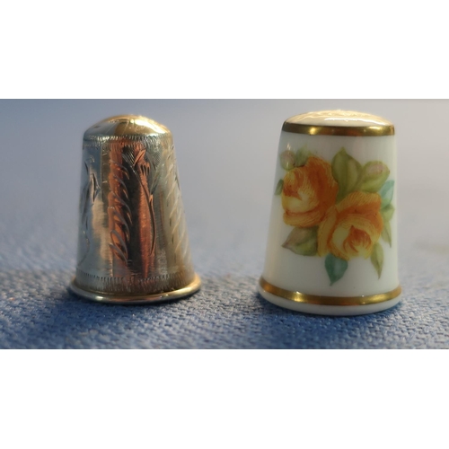 62 - Three silver hallmarked thimbles, a folding button hook and a Royal Worcester thimble (5)