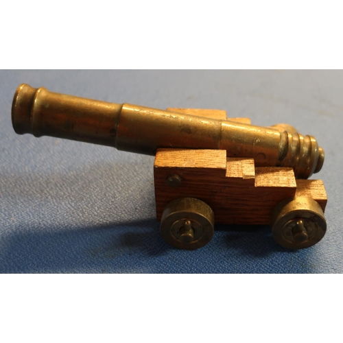 64 - Brass model of a cannon with 15cm staged barrel on oak carriage