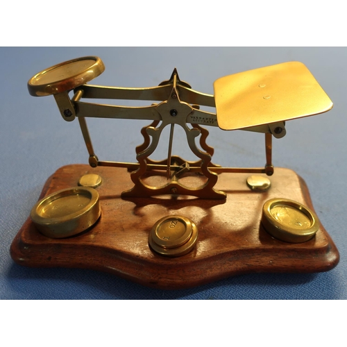 65 - Set of brass postage scales mounted on mahogany plinth stamped 'Warranted Accuracy' with a small sel... 