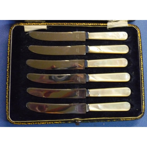 36 - Cased set of cake knives with silver handles, hallmarked  Sheffield 1910 and a case of knives with m... 