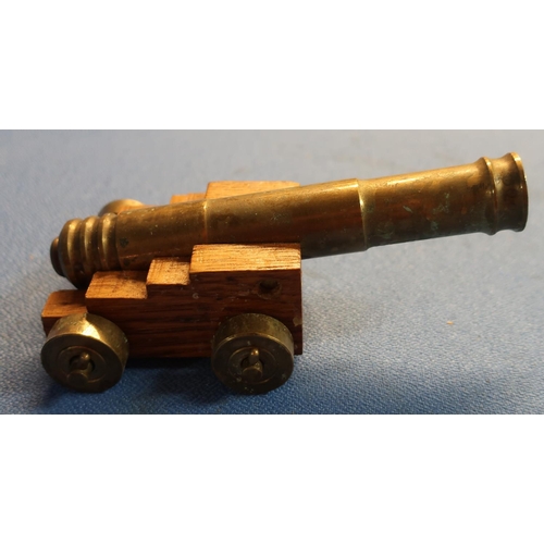 64 - Brass model of a cannon with 15cm staged barrel on oak carriage