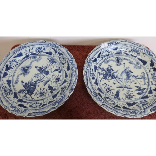 50a - Large pair of Chinese blue & white shallow chargers with central panels depicting figures on horseba... 