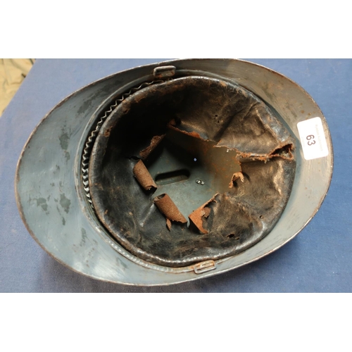 63 - WWI French artillery steel helmet with traces of painted detail complete with leather liner.