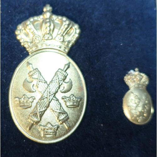 68 - Framed and mounted display of Belgium gilt metal cap badges, buttons etc (23cm x 33cm)