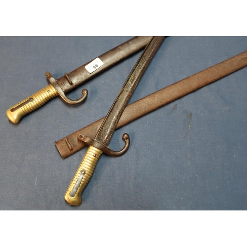 96 - Two 19th C French Chassepot bayonets, with steel scabbards and ribbed brass grips