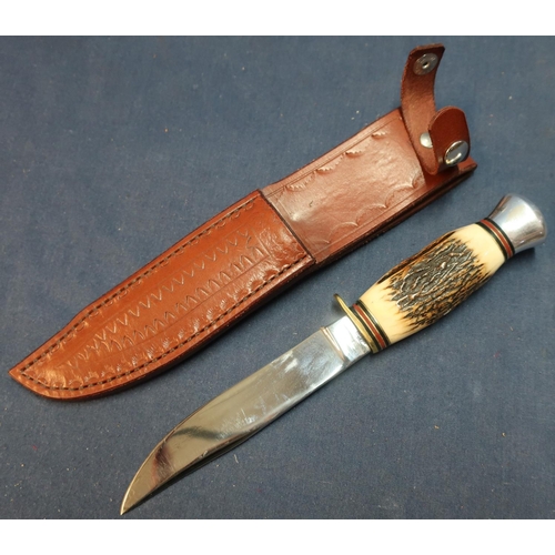 277 - German made sheath knife with 4 1/2 inch blade and horn grip, complete with tooled leather sheath