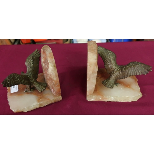 81 - Pair of rough cut onyx style bookends with cast metal figures of eagles with outstretched wings