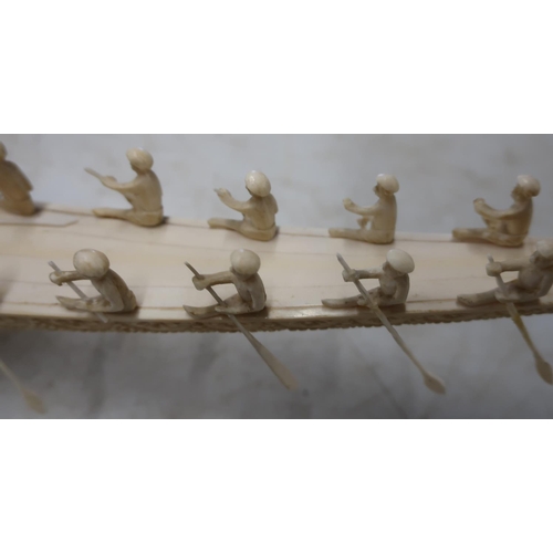 173 - Early 20th C Persian carved ivory tusk in the form of a boat with various figures mounted on rectang... 
