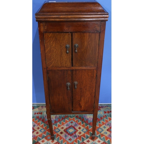179 - Early 20th C oak cased gramophone with hinged top and four cupboard doors, with various records etc ... 