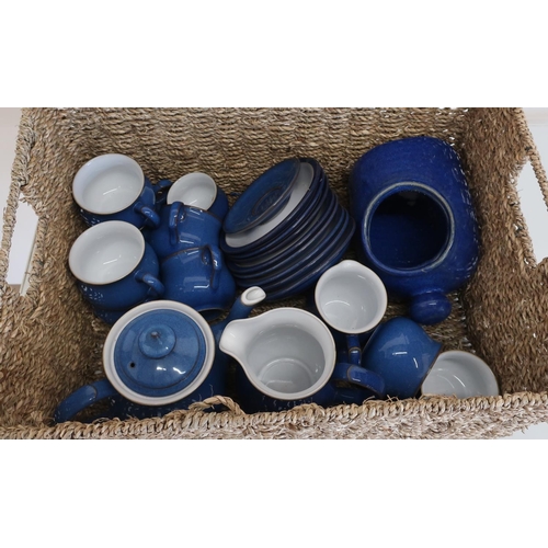 151 - Rectangular wicker basket containing a part Denby blue tea service with eight cups, milk jug, water ... 
