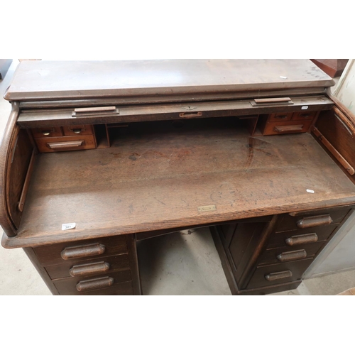 301 - Edwardian oak twin pedestal roll top desk with fitted interior (width 122cm)