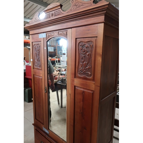 315 - Late Victorian beech wardrobe enclosed by single bevelled edge mirrored door with carved and panelle... 