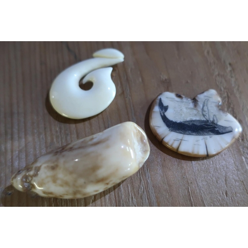 365 - Three carved Inuit style marine ivory figures, one with engraved detail of a bird, another of a whal... 