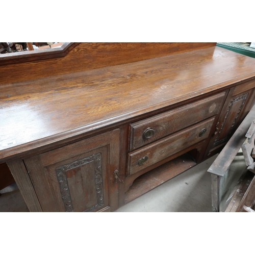 380 - Large oak sideboard with raised back above two central drawers and open shelf, flanked by two carved... 