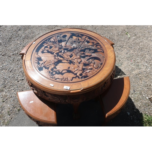 384 - Oriental carved hardwood circular occasional table with carved detail to the top and glass panel, wi... 