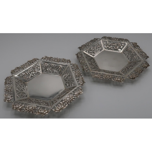 392 - Pair of Chinese silver dishes with pierced floral borders (diameter 11cm) with signature panel to th... 