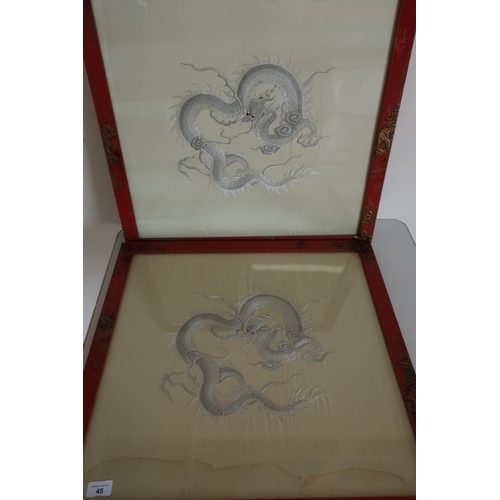 45 - Pair of framed and mounted embroidered Oriental silkwork panels of dragons in red chinoiserie frames... 