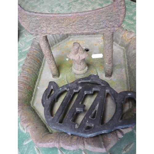 46 - Ornate boot scraper and a cast iron teapot stand in the shape of a teapot
