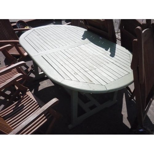 210 - Large wooden garden table with eight folding chairs