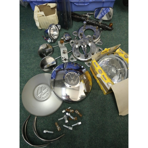 318 - Collection of various VW camper spares, including hub caps, head lamps, mirrors, covers, various par... 