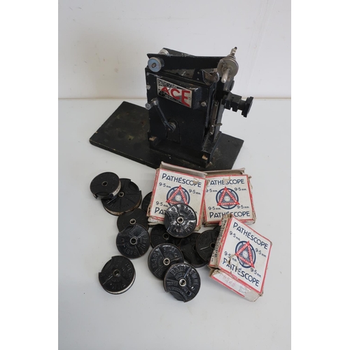 43 - Pathescope 9.5MM film projector and a large selection of various assorted Pathescope baby film reels... 