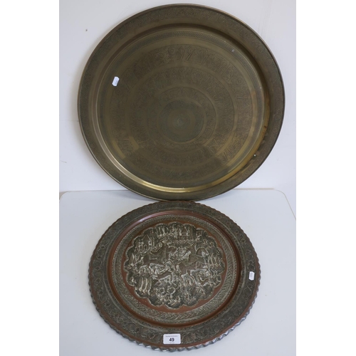 49 - Large Persian style charger with embossed detail and another similar Egyptian style brass charger, a... 