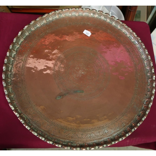 10 - Extremely large Eastern copper charger with engraved detail and raised pie crust edge, with traces o... 