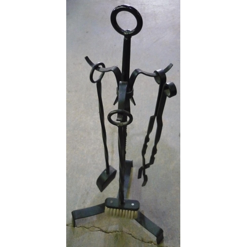 129 - Wrought metal fire companion set on stand, and a standard lamp with cast metal hanging top (2)