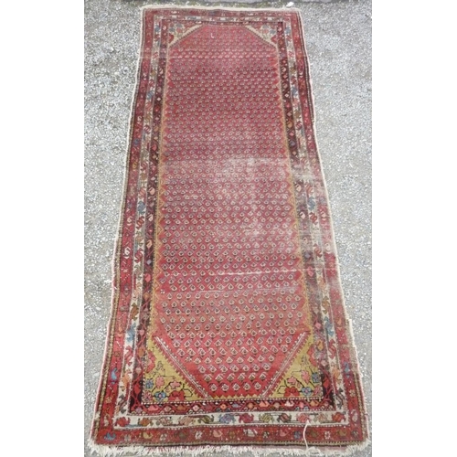 71 - 20th C Indo-Persian runner, red ground with geometric pattern border (300cm x 116cm)