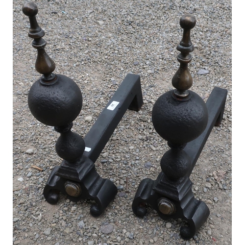 20 - Pair of heavy wrought metal and brass fire dogs with turned finials (50cm high)