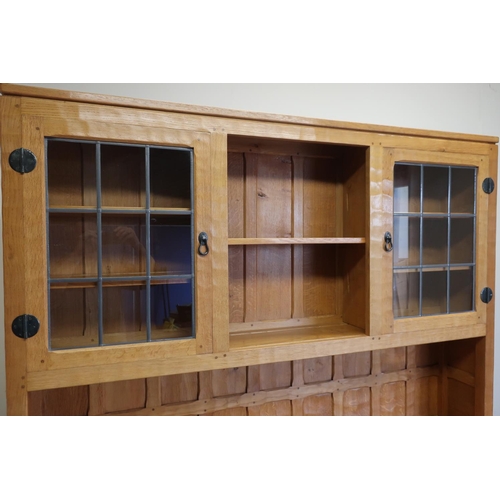 137 - Yorkshire oak craftsman made Mouseman style dresser, the upper section with two tier open centre fla... 